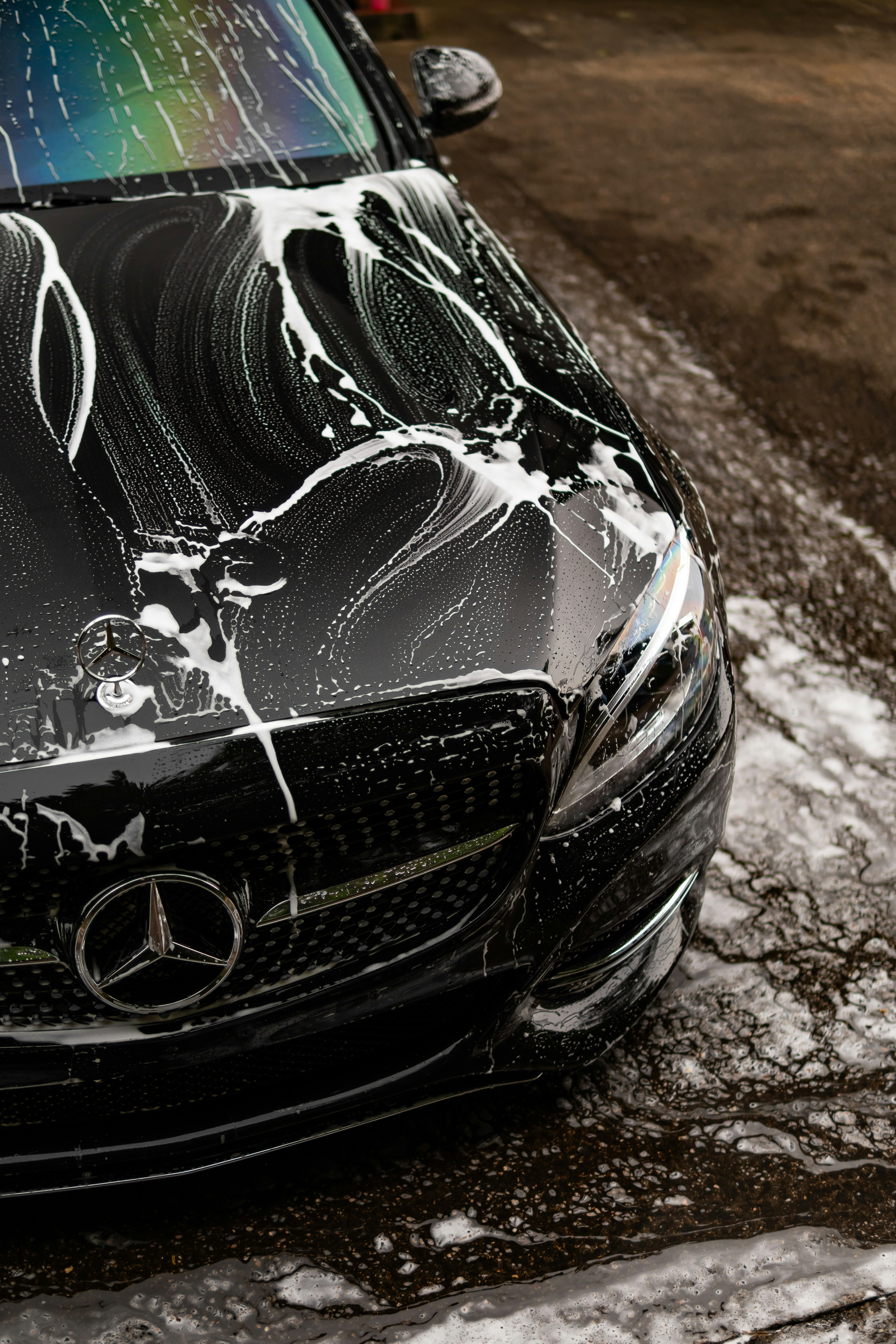Man washing a car in a garage